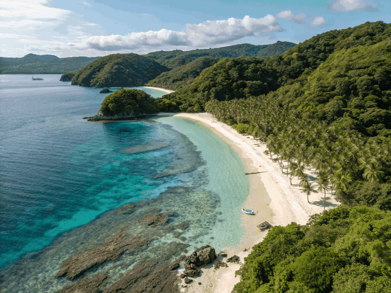 Crystal clear blue waters and white sandy beach at Pagudpud lagoon